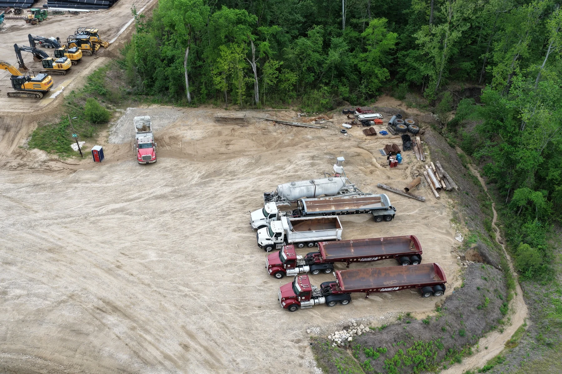 Aerial view of trucks and heavy equipment in an operating yard